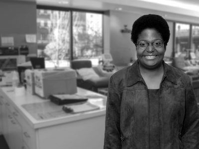 Black and white image of a volunteer standing in a donor center